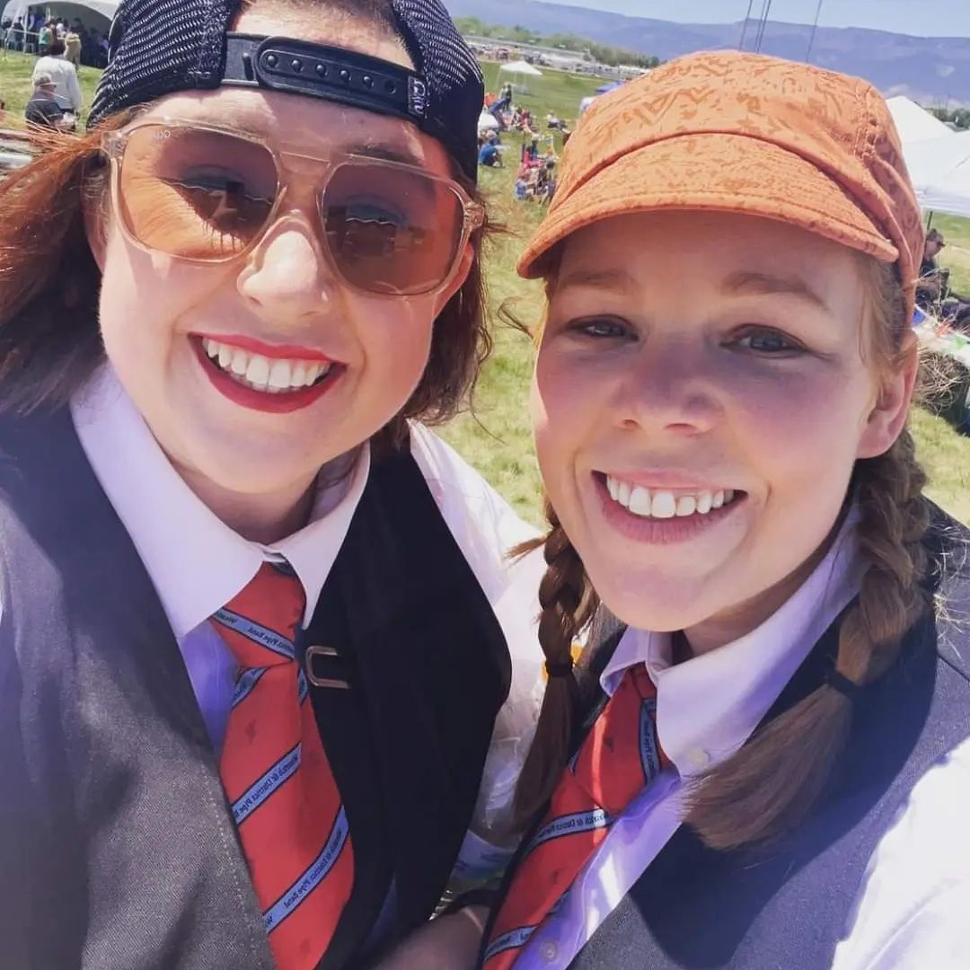 Two female bagpipers in traditional attire at the Grand Junction Highland Games